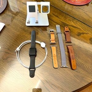 Apple 3 series watch (38mm) with bands, charging cord, & charging stand.